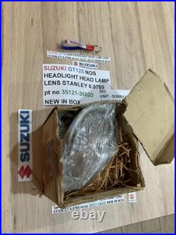 SUZUKI GT125 NOS HEADLIGHT HEAD LAMP LENS STANLEY 6.0789 pt no 35121-36020 NEW