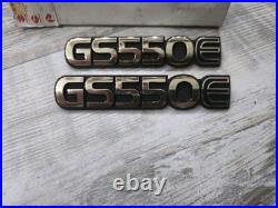 Suzuki GS550E PAIR SIDEPANEL BADGES NOS rare golds colour 68131-47300